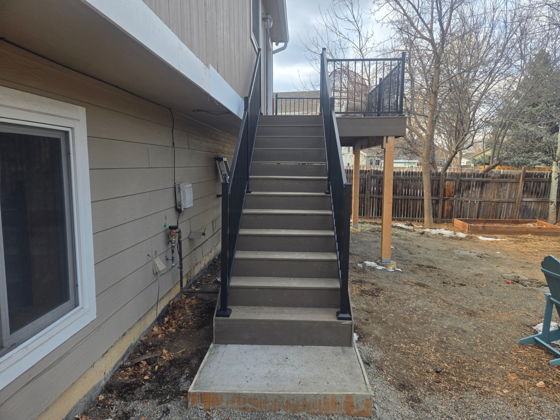 New composite deck with black aluminum railing and matching stair run in Fort Collins