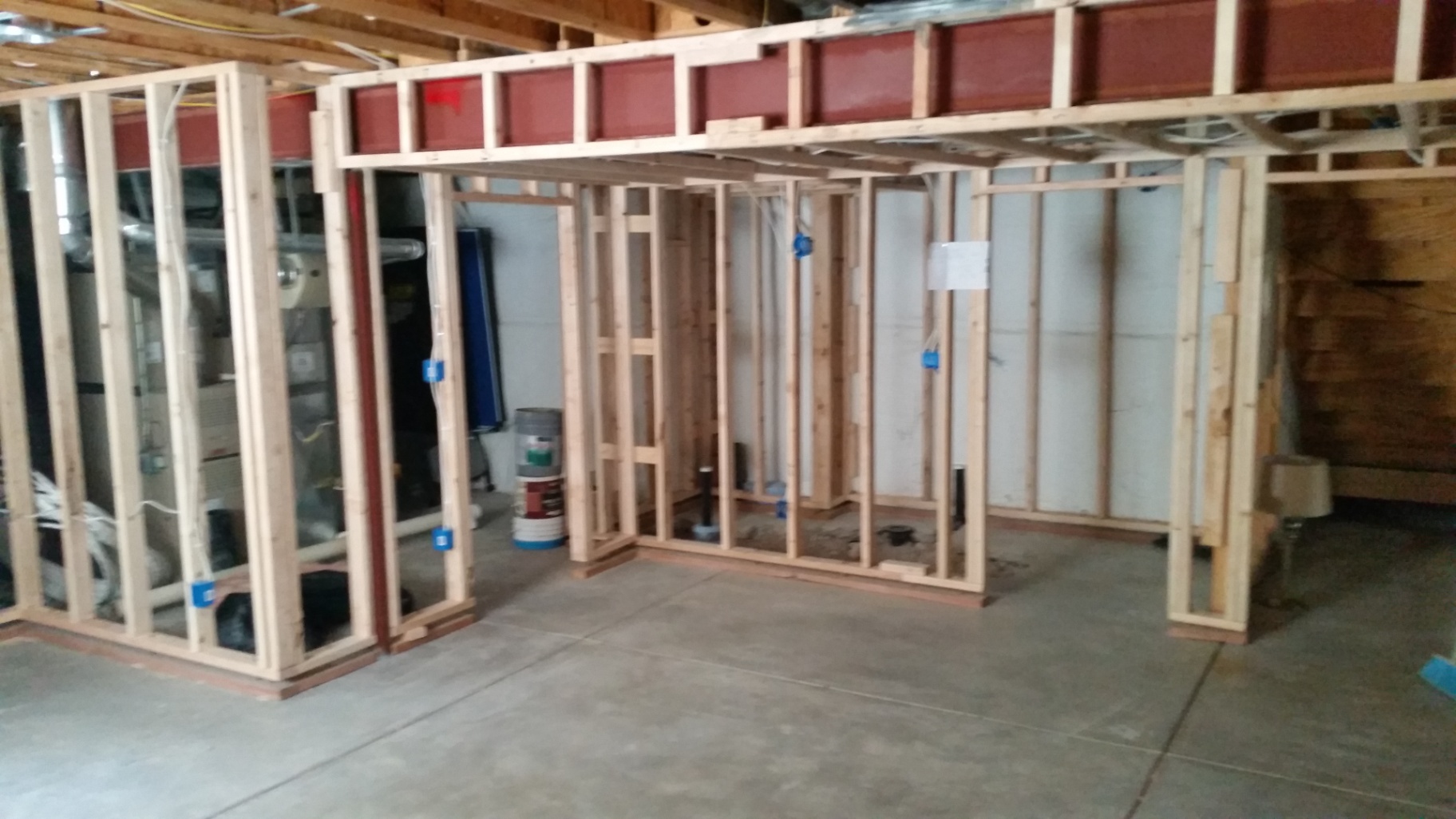 Interior basement framing with headers and electrical rough-in