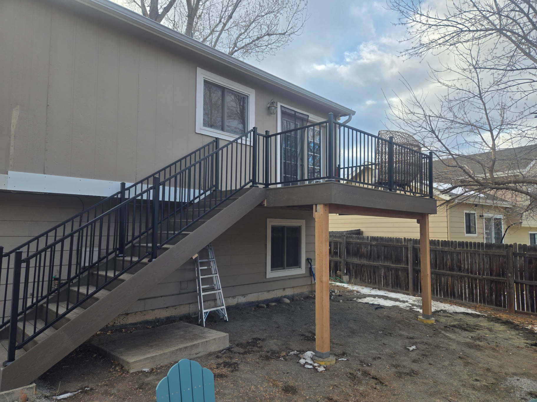 Elevated composite deck build with stairs, posts and aluminum railing